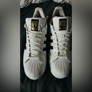 adidas White Sneakers with Black Stripes and Gold Tongue Accent